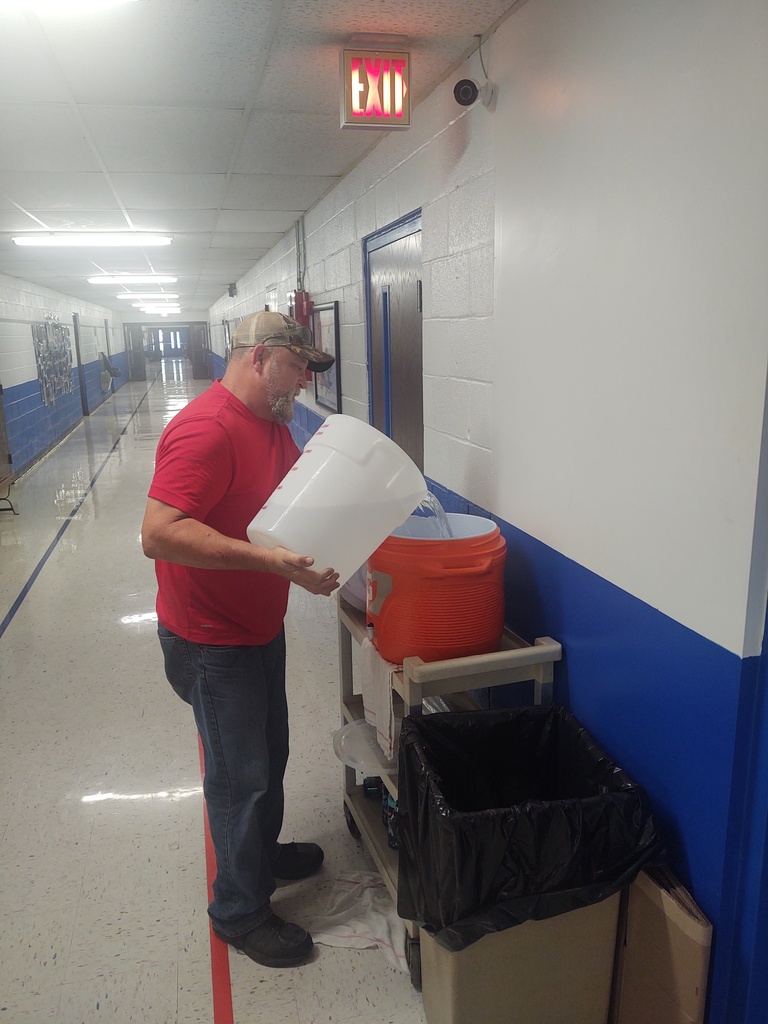 Mr. Charles making sure are students have ice cold water to drink.